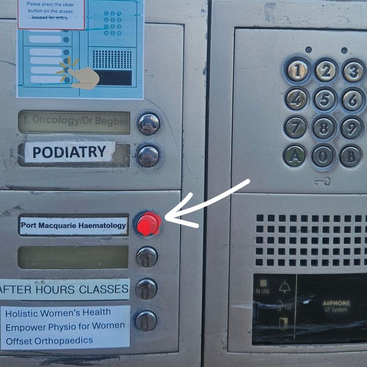 Intercom panel at the car park boom gate, with an arrow to the button beside the Port Macquarie Haematology label, marked in red